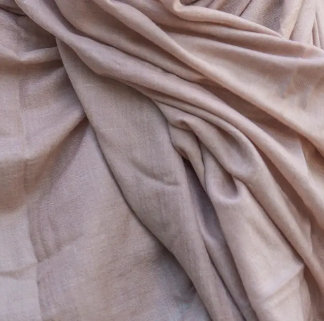 Powder pink pashmina fabric arranged in soft folds